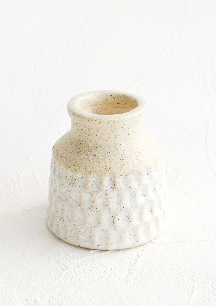 1: Short ceramic vase in raw speckled ceramic with pale blue glaze and indented texture