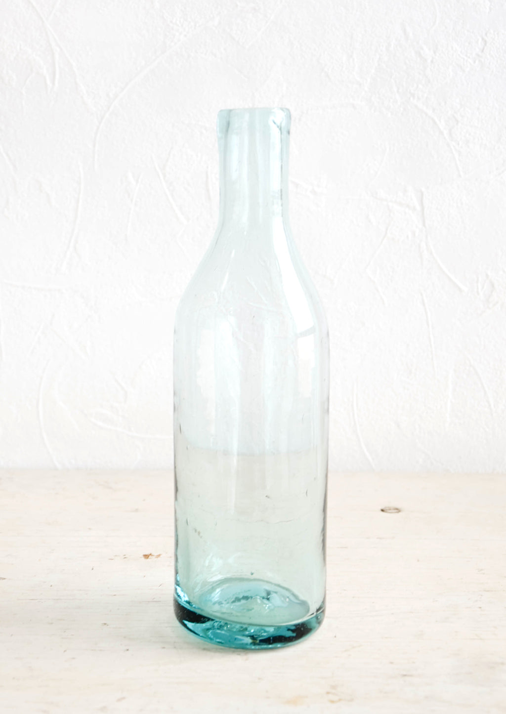 Clear: Wine-bottle shaped glass bottle in clear recycled glass