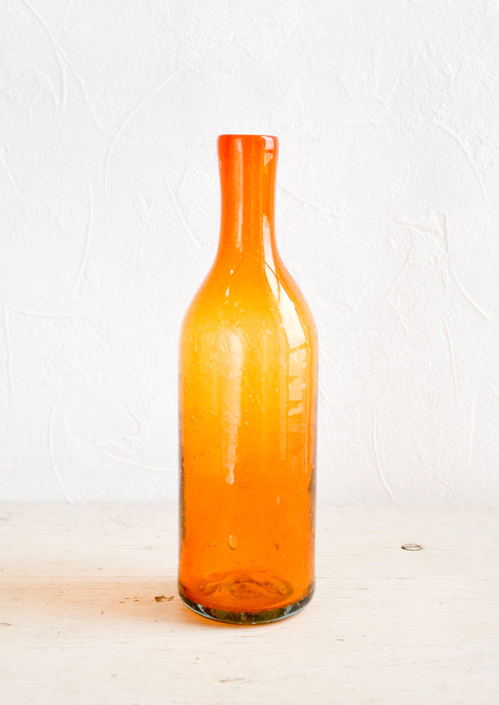 Orange: Wine-bottle shaped glass bottles in tinted orange hue