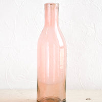 Rose: Wine-bottle shaped glass bottles in tinted pink hue
