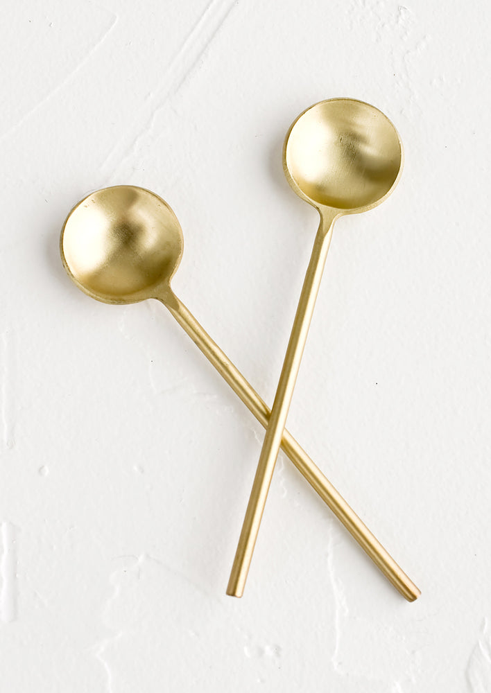 1: Two small golden spoons.