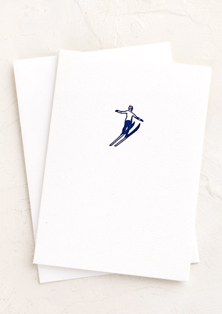 1: A white card with a blue skier icon.