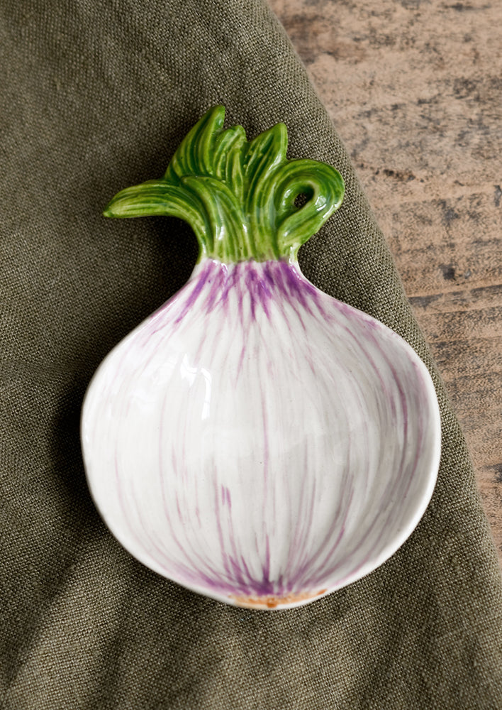 A ceramic veggie dish in the shape of a spring onion..