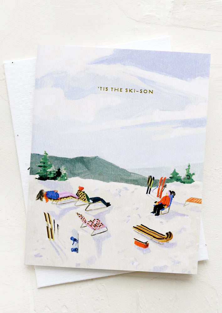 1: A card with illustration of skiers relaxing on a hill, text at top reads "Tis the ski-son".