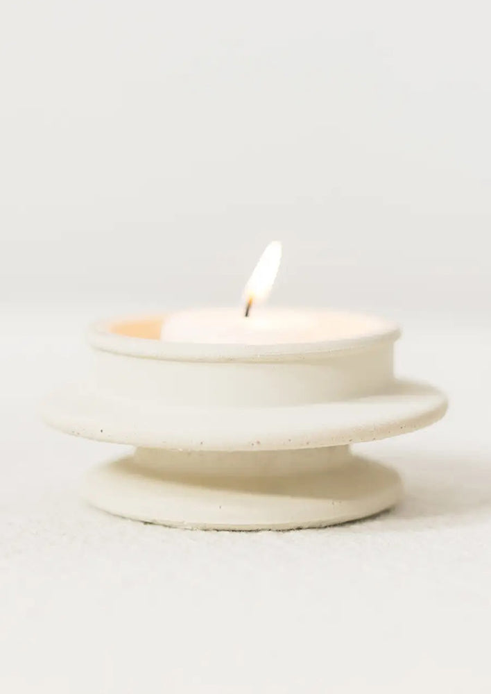 White: An architecturally shaped tealight holder in white.