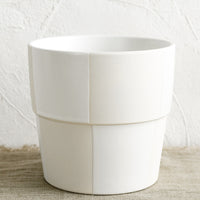 1: A large cream and white checker patterned planter pot.