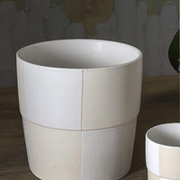 2: A cream and white checker patterned planter pot.