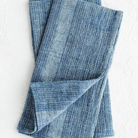 Indigo: A pair of indigo fabric napkins with textured tonal stripe pattern.