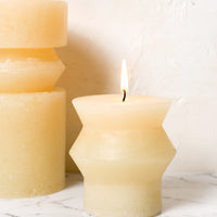 Small / Vanilla: Vanilla colored pillar candles in assorted sizes.