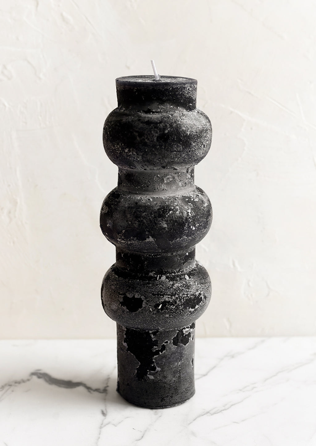 Large / Black: A large hourglass shaped pillar candle with waxy finish in black.