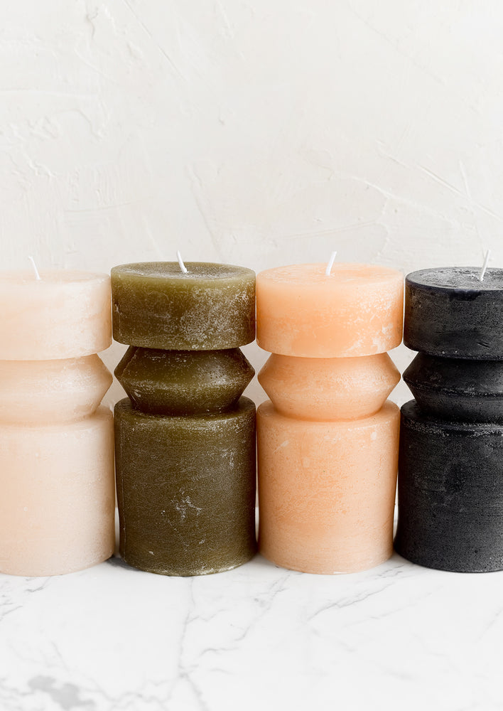 Assorted colors of geometric carved shape pillar candles.
