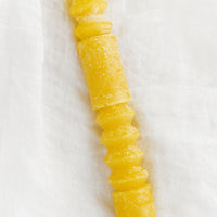 Beeswax: A geometric shape taper candle in beeswax (yellow).