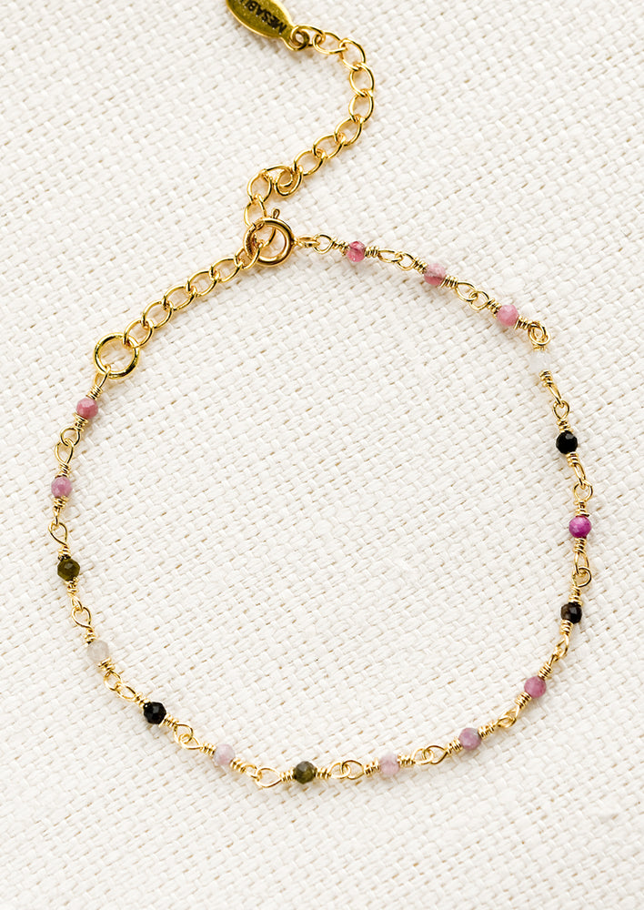 2: A gold wire bracelet with small multicolor tourmaline beads.