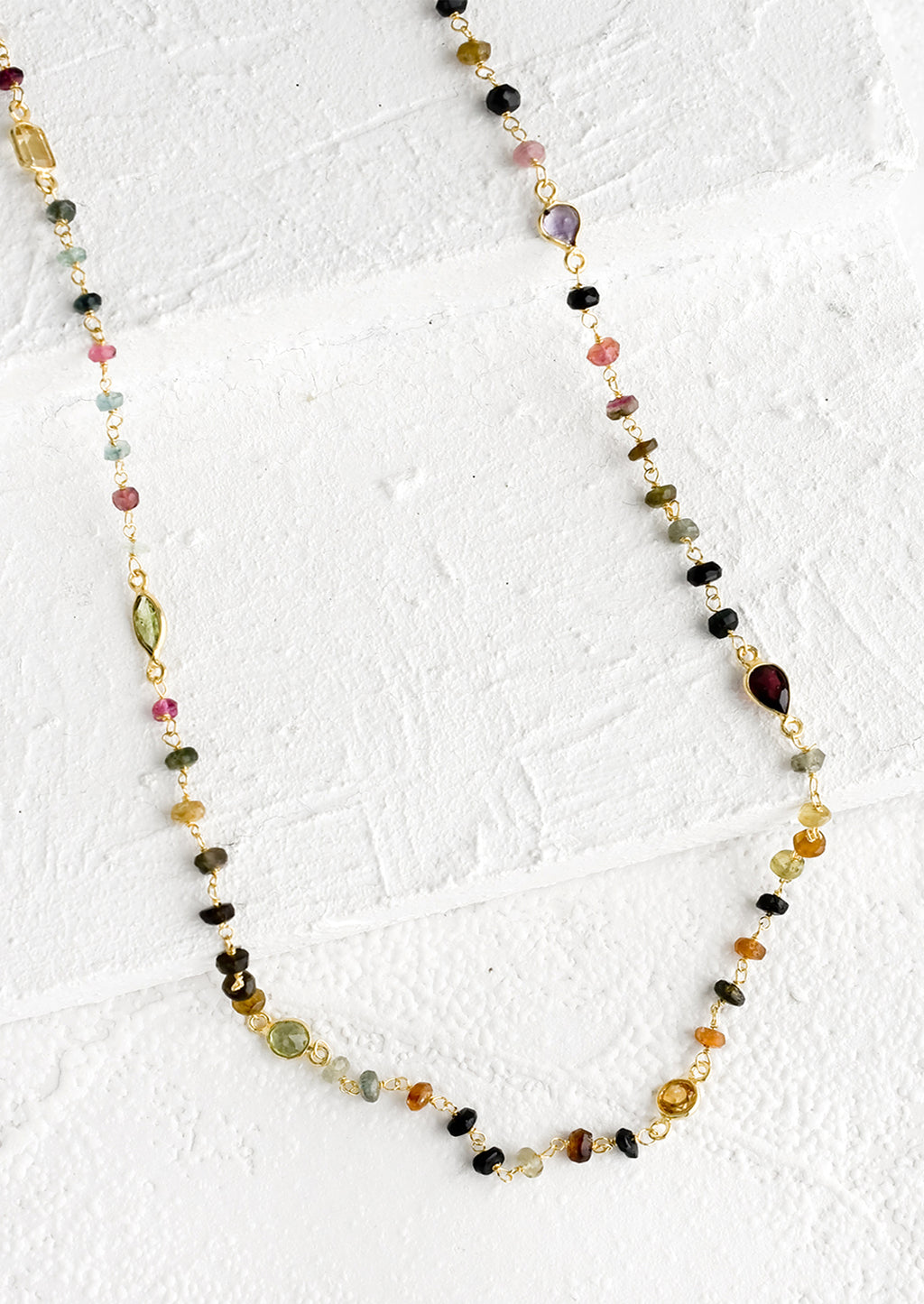 1: A long necklace with multicolor gemstones and tourmaline bezel.