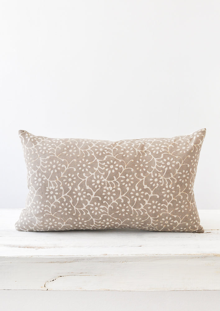A grey and white floral block-printed 12x20 pillow.