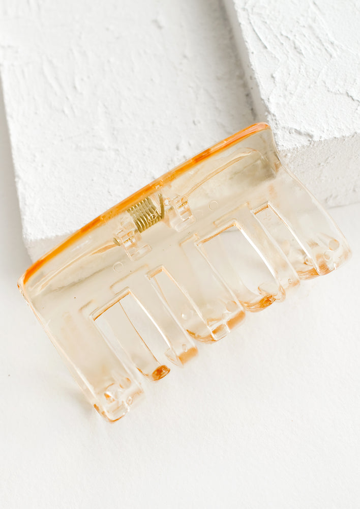 A transparent hair clip in pale honey.