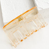 Pale Honey: A transparent hair clip in pale honey.