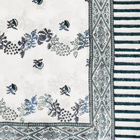 3: A block printed floral tablecloth in white and blue.
