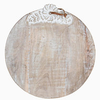 3: A round wooden cutting board with shabby chic floral detailing.