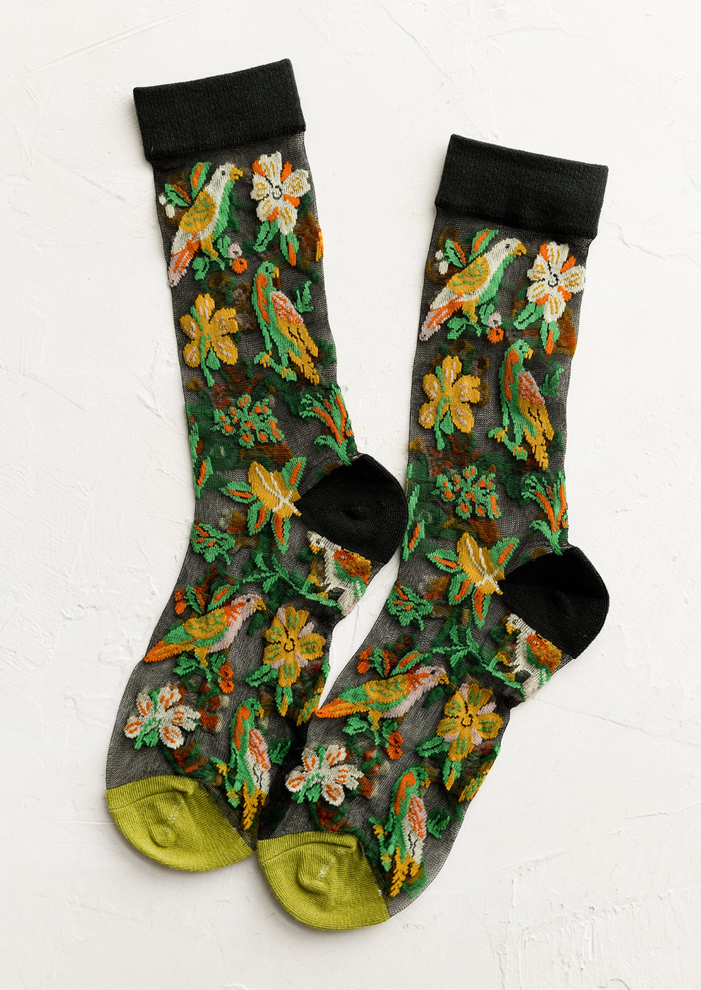 1: A pair of sheer black socks with tropical parrot print.