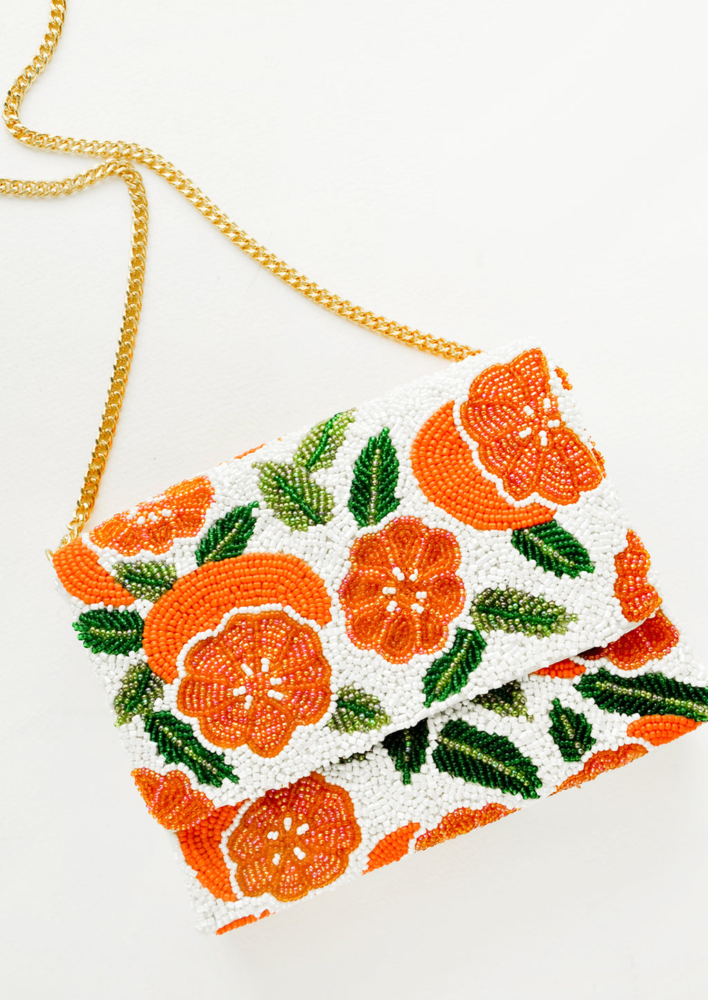 3: Beaded box-shaped clutch with orange citrus print and gold chain shoulder strap