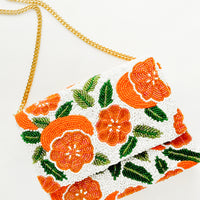 3: Beaded box-shaped clutch with orange citrus print and gold chain shoulder strap
