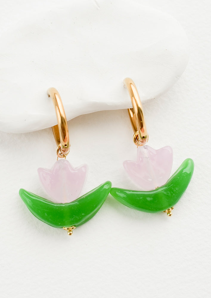 Pink: Glass earrings in the shape of a tulip in pink, with gold huggie hoop base.