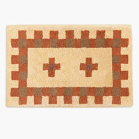 Hazelnut / Terracotta / Cocoa: A bath mat in geometric cross print in peach, terracotta and brown.