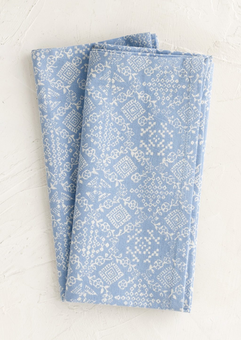 Powder Blue: A pair of blue napkins with white tile print.