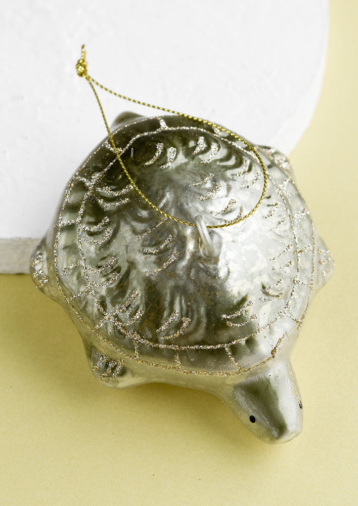 1: A glass holiday ornament of a turtle.