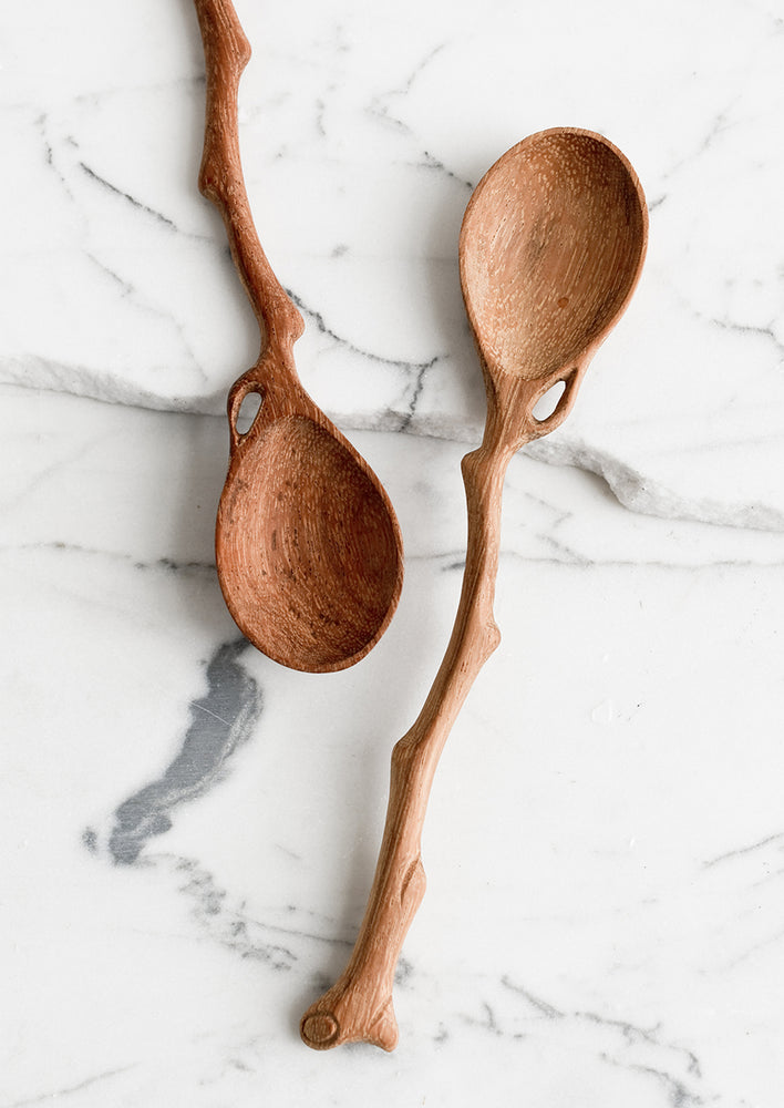 1: A wooden spoon in shape of tree branch.