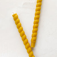 Beeswax: Two twisted taper candles in beeswax color.