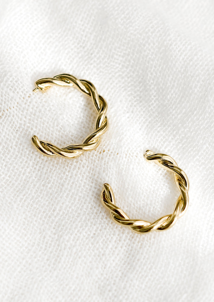 2: A pair of gold twist hoop earrings.