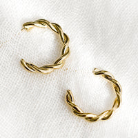2: A pair of gold twist hoop earrings.