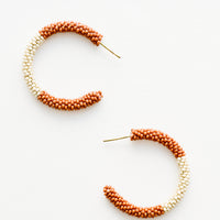 Rust / Ivory: Rust and ivory colorblock beaded hoop earrings.