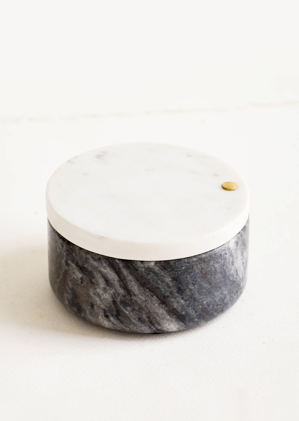 1: Round salt cellar made of black marble with white marble lid