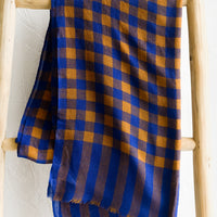1: A lightweight woven wool scarf in blue and caramel gingham.