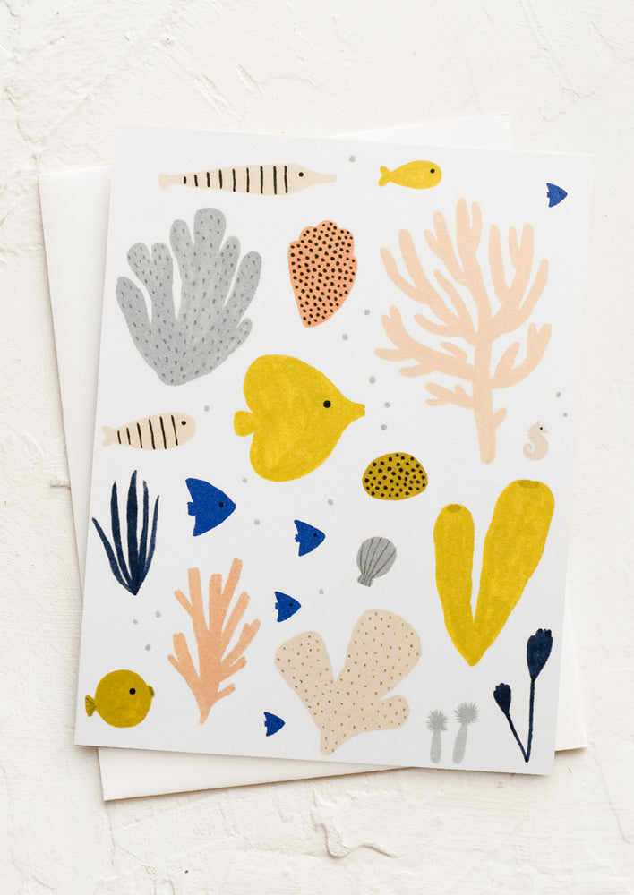 A card with illustration of fish and coral.