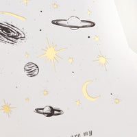 2: A greeting card with black and gold planets and text reading "You are my universe".