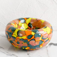 1: A speckled multicolor glass bowl in teal, peach, orange and yellow.