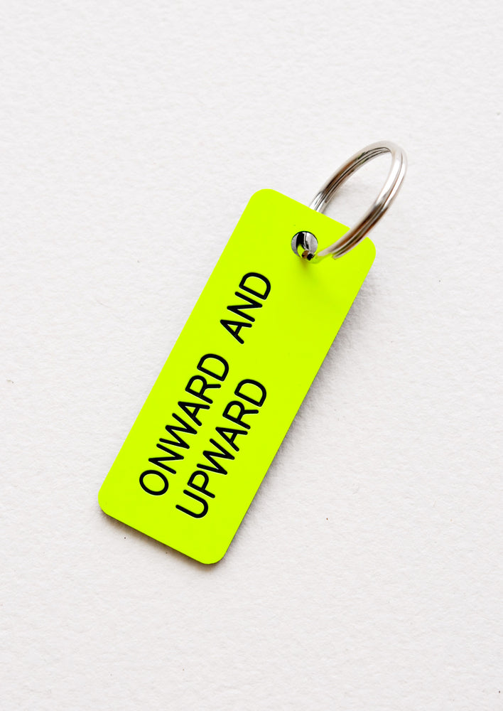 Small acrylic keychain, neon yellow background with black words that says "ONWARD AND UPWARD"