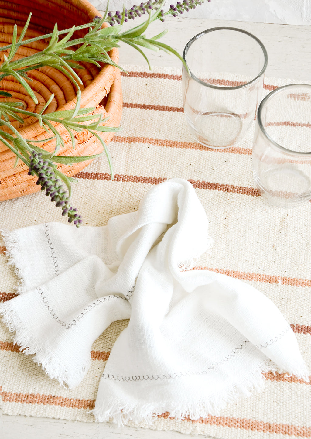 Natural / Blush / Terracotta: Serene table setting with neutral and white table linens and glass cups