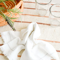 Natural / Blush / Terracotta: Serene table setting with neutral and white table linens and glass cups