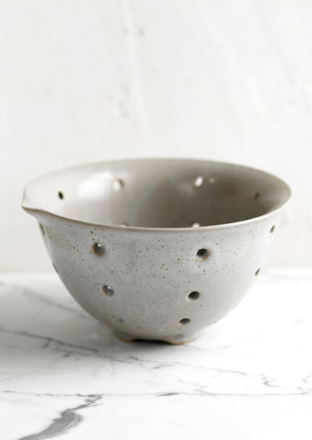 Greige: A greige ceramic stoneware colander.