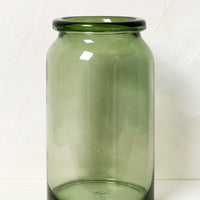 2: A tall, clear green glass vase with rolled rim.