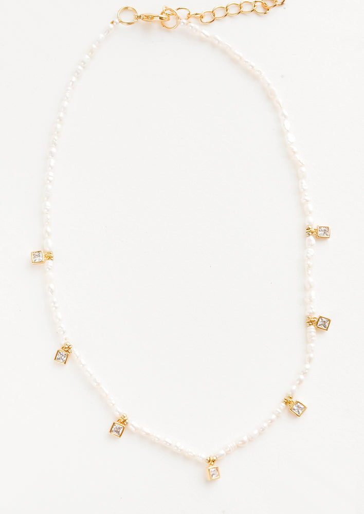 Pearl beaded necklace, accented with square crystal stations