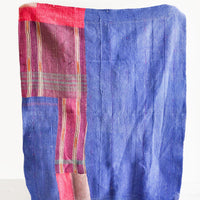 2: Vintage patchwork quilt in a mix of colors and fabrics. Predominantly dark blue with magenta accents.
