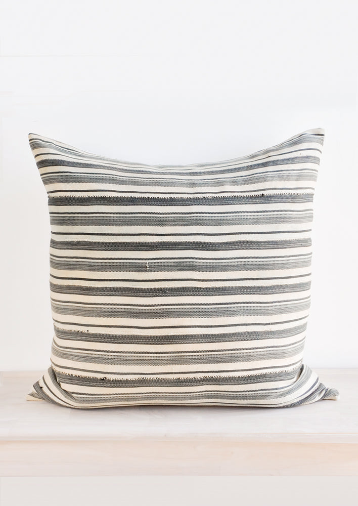 1: Square throw pillow in faded vintage fabric with allover tan and grey stripes