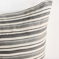2: Close up of fabric on throw pillow in faded vintage fabric with allover tan and grey stripes