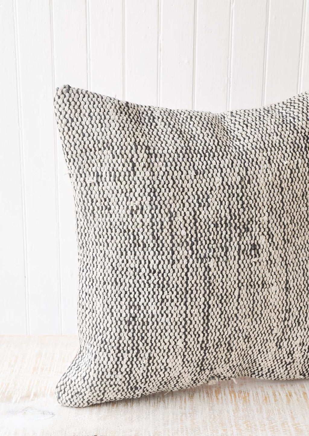 2: A black and white woven pillow with wavy lines.